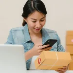 Personne préparant un colis à expédier après une vente en ligne